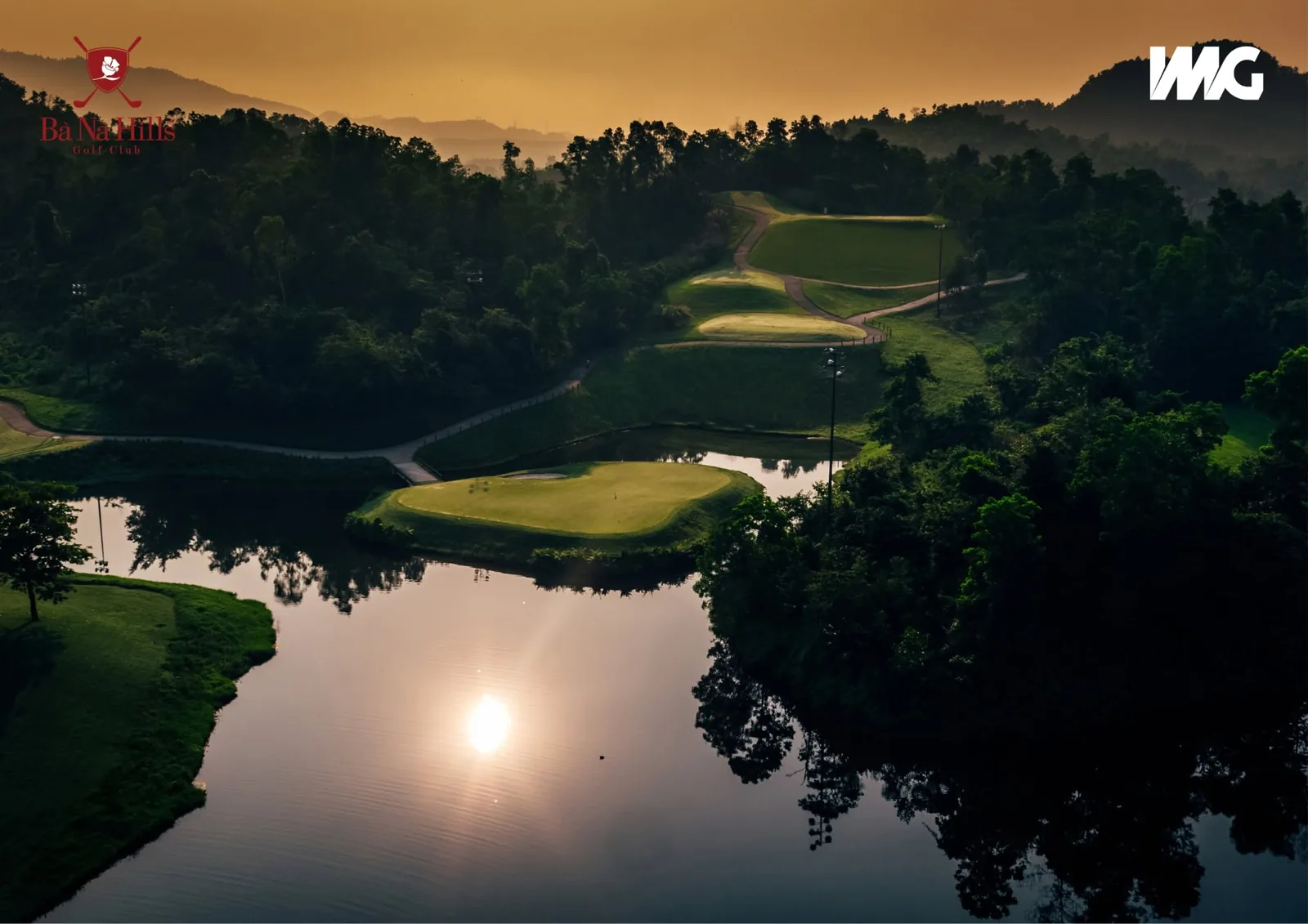 Sunset over the lake and island green at Ba Na Hills Golf Club